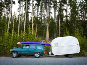 A profile view of a car hitched to a trailer, showing the uneven tongue weight.