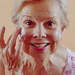 old woman with face lotion