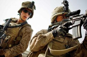 U.S. military personnel, like these Marines photographed in Afghanistan on July 9, 2009, are equipped with the world's most advanced weapons systems. See more gun pictures.