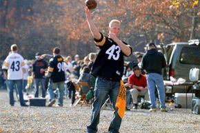 A fan of the Pittsburgh Steelers throws a pass while tailgating before play against the Cincinnati Bengals at Heinz Field in Pittsburgh, Pa.