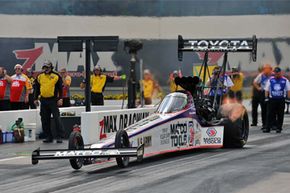 Driver Antron Brown launches the Matco Tools Top Fuel dragster at the zMAX Dragway in Concord, North Carolina.