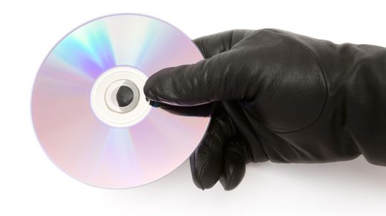 What happens if I touch the surface of a CD?