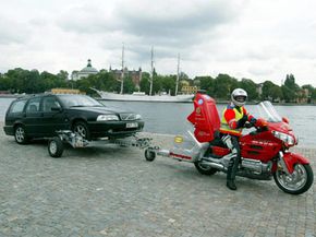 A tow dolly lifts the drive wheels off the ground