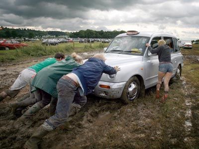 Festival goers try to push a taxi cab stuck in the mud at the Glastonbury Festival in Somerset, England. If only they had another towing vehicle with the right tow hooks &hellip;