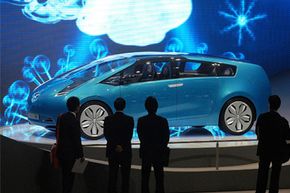 Visitors look at the new Toyota Hybrid X Concept car during a media preview day at the 77th Geneva International Motor Show in Geneva, Switzerland, on March 7, 2007. See more hybrid car pictures.