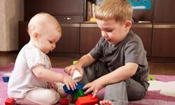 brother and sister playing with blocks