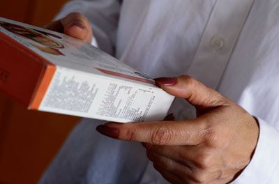 Person reading back of cereal box