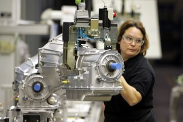Donna Ramsey moves transmissions in the final assembly area at the General Motors Willow Run plant in Ypsilanti, Mich., on Oct. 26, 2005.