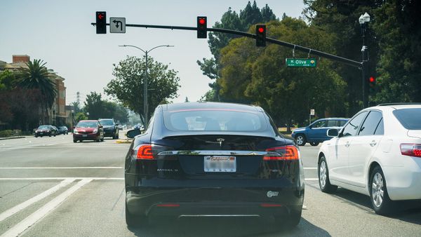 tesla car at traffic light