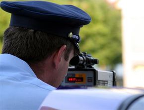 Be careful of police officers using radar guns or lidar to catch speeders. Often they will be positioned in a parking lot on the side of a road or around a bend in a highway.