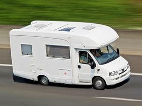 A compact camper van on a highway