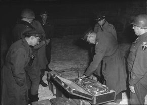 General Dwight Eisenhower inspects Nazi gold uncovered by Allied forces in 1945.