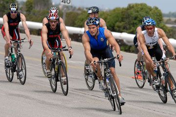 Athletic men cycling outdoors.