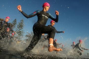 Person sprinting outdoors with speed and motion.