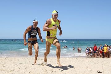 Men enjoying summer outdoors on sandy beach.