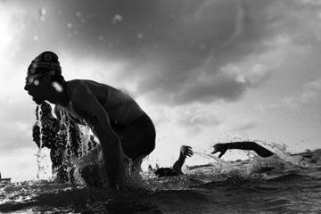 Person and men enjoying outdoors in nature's water.