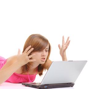 A woman is frustrated while using a laptop