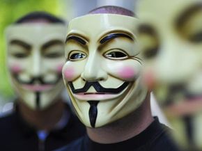 A member of&nbsp;Anonymous in a mask