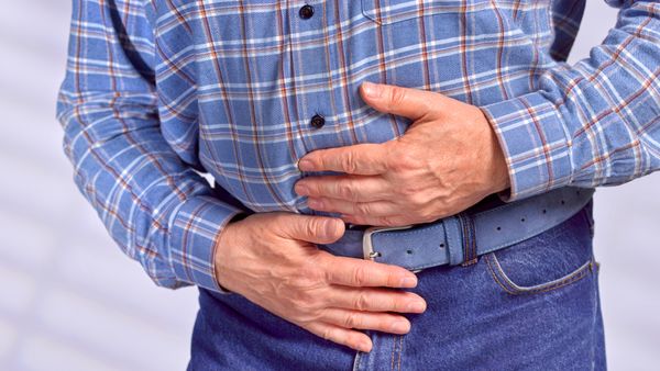 Man Holding His Stomach with Ulcer Pain