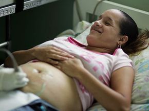 Pregnancy Image Gallery ­Enedino Ortega, four months pregnant, lies on a bed as Zaditza Silveira uses an ultrasound machine to take images of her baby at the Birthing Center of South Florida. See more pregnancy pictures.