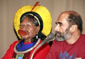 Raoni Metyktire, leader of the Kayapo Indian Amazon tribe, and Brazilian environmentalist Paulo Pinage speak at a press conference in 2007. Some Amazonian tribes remain uncontacted by the outside world, but all tribes are threatened by deforestation.