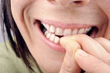 Nervous woman biting her nails.