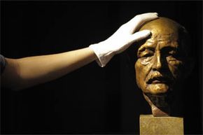 A bust of Max Planck gets a quick dusting. Planck is known as one of the founding fathers of quantum theory.
