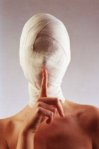 person with bandaged head