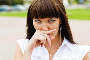 Woman pressing on upper lip