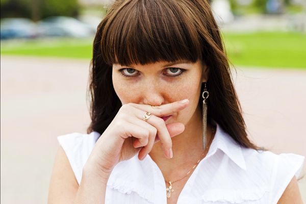 Woman pressing on upper lip