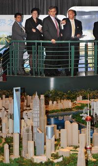 British and Chinese officials at the Urban Planning Museum in Shanghai, China, see a model of Shanghai in 2015.
