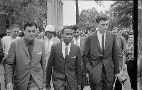 James Meredith, walking to class at the University of Mississippi, is escorted by U.S. Marshals.