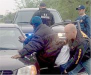 U.S. Marshal multi-agency member searching a fugitive.