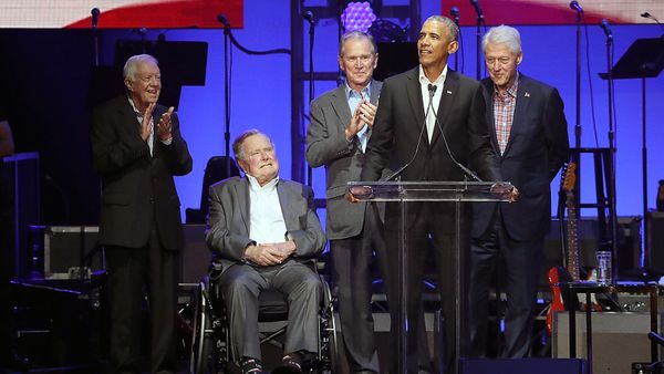 Men in suits performing on stage.