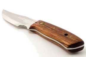Sharp metal penknife with handle and blade.