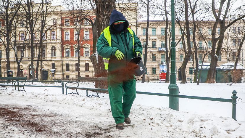 Polish worker sprinkles coffee grounds