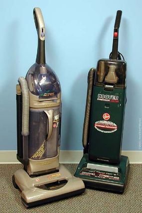 Two upright vacuum cleaner models, one with the conventional bag system (right), and the other with the new "cyclone" system (left).”border=