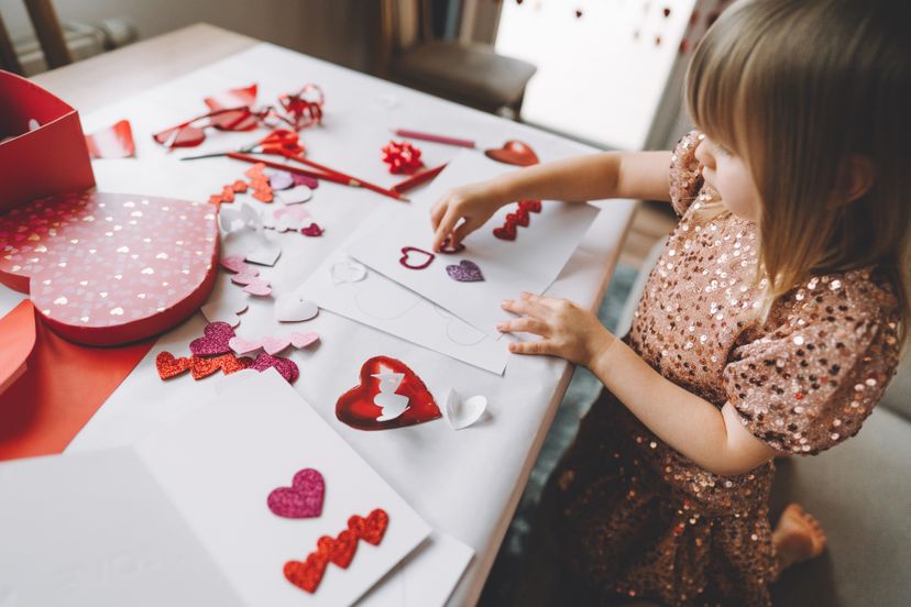 Toddler making greeting card for mom and dad at home