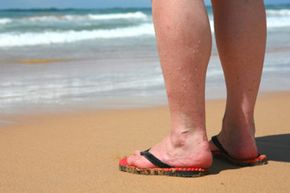 Close-up of woman's calves on beach