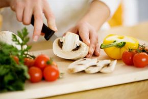 female chopping food ingredients