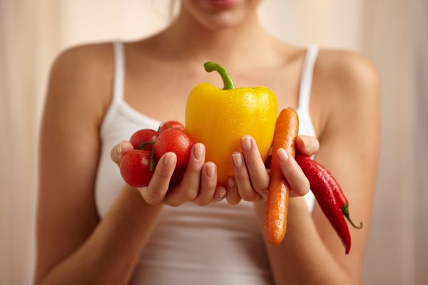 Woman holding vegetables