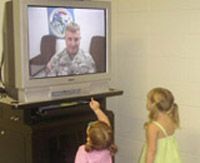 Army Sgt. 1st Class Jeffrey Everman visits with his children in Texas.