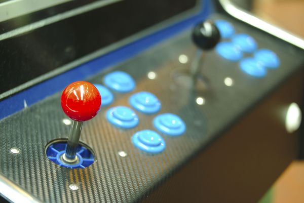 Old stand-up video game console with joystick and buttons