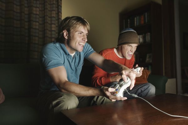 Two gamers playing in living room