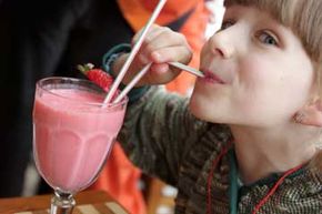 Little girl drinking pink mocktail