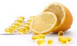 Fresh lemon fruit and vitamin c or omega 3 capsules.healthcare and medicine products - yellow gel capsules.