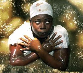 A woman in a trance stands in a pool of water during a voodoo Easter ceremony, April 16, 2006.­