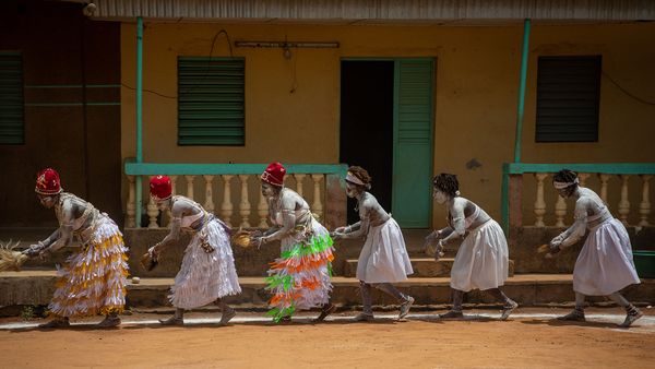 Men and women of diverse cultures dancing in festive dress.