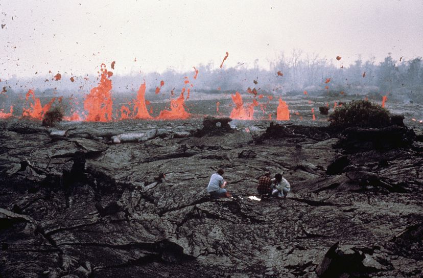 scientists in front of a lava flow