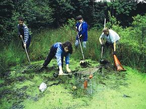 Volunteers cleaning out pond.